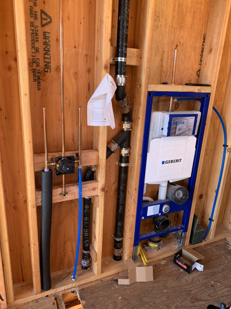 Geberit Sigma in-wall toilet tank system and copper rough-in plumbing installed inside a framed wall